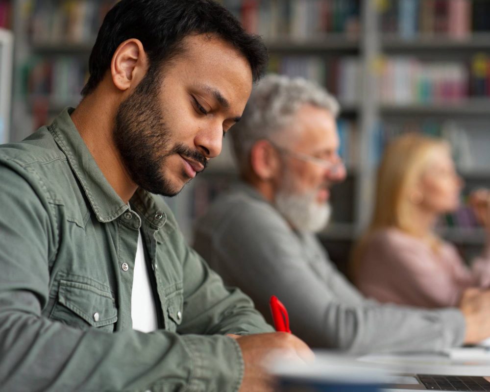 medium-shot-adults-studying-together(1)